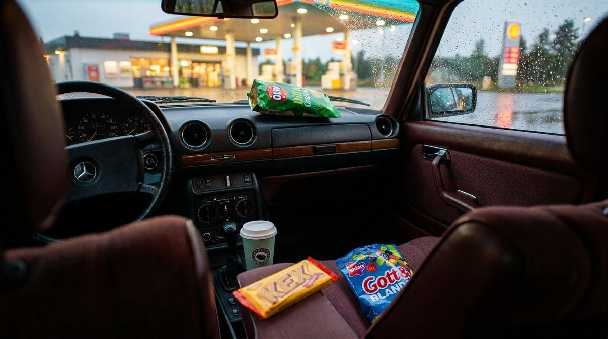 Swedish road trip snack stop with Kexchoklad, Gott & Blandat, coffee and potato chips inside a 1985 Mercedes at a petrol station.