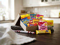 Swedish Candy Box Large open on a wooden table – Ahlgrens Bilar, Polly, Gott & Blandat, Djungelvrål, Plopp, Kexchoklad, Daim, Malaco Zoo, Marabou Nougat, Polkagris and Ahlgrens Bilar Saltlakrits inside
