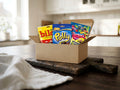Swedish Candy Box Small open on a wooden table – Ahlgrens Bilar, Cloetta Polly, Malaco Gott & Blandat and Djungelvrål inside
